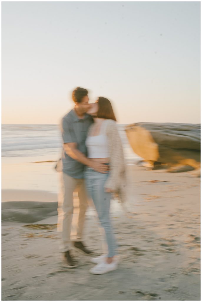 blurry photo of couple during beach engagement session location