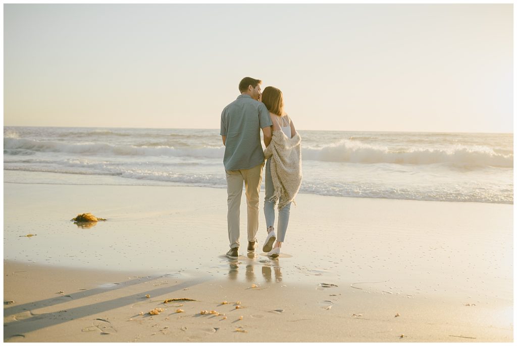 park and beach outdoor engagement session - san diego wedding and lifestyle photographer - couple kissing in front of ocean enagement location