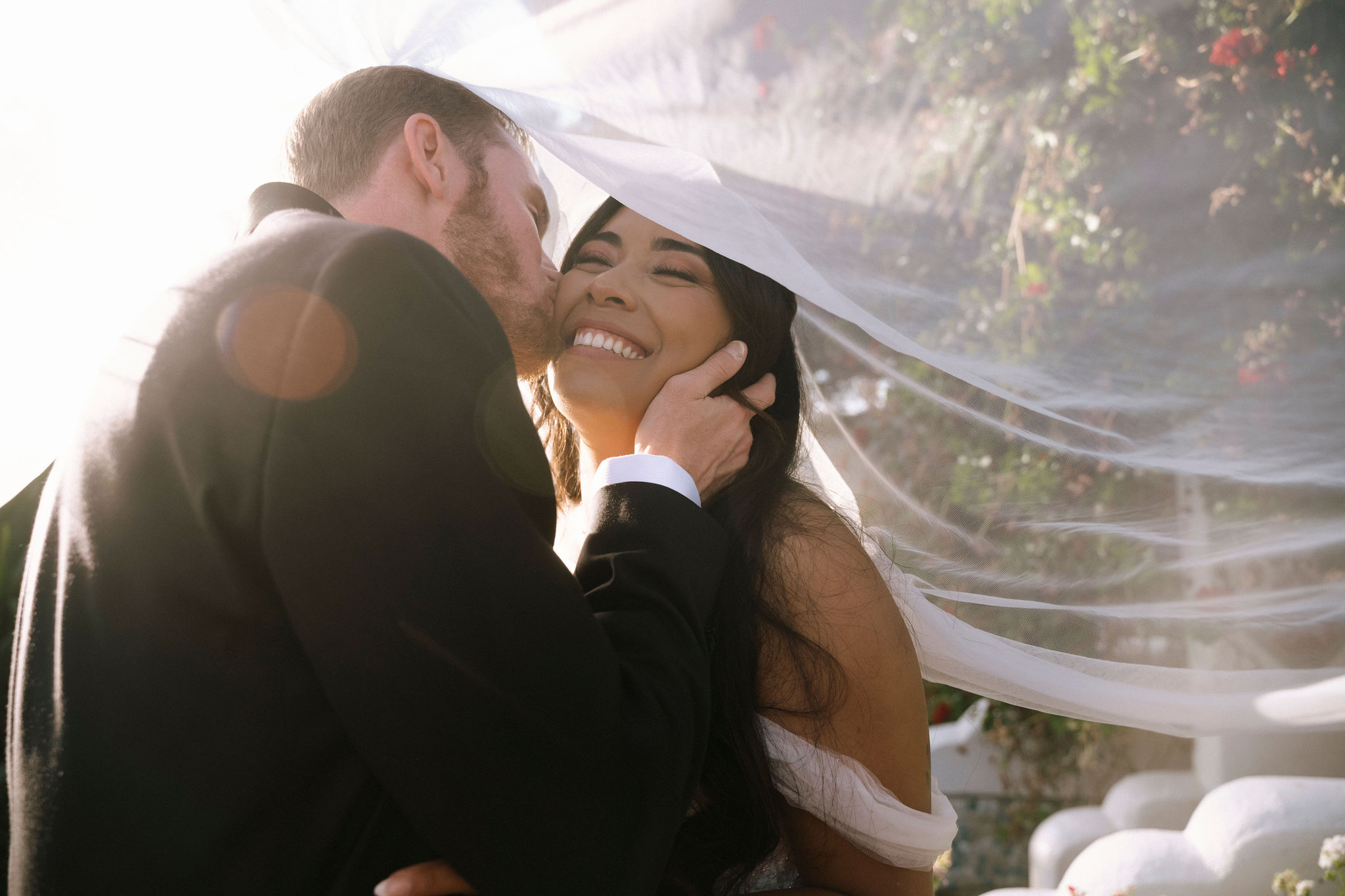 A couple kissing during their elegant Tivoli wedding.