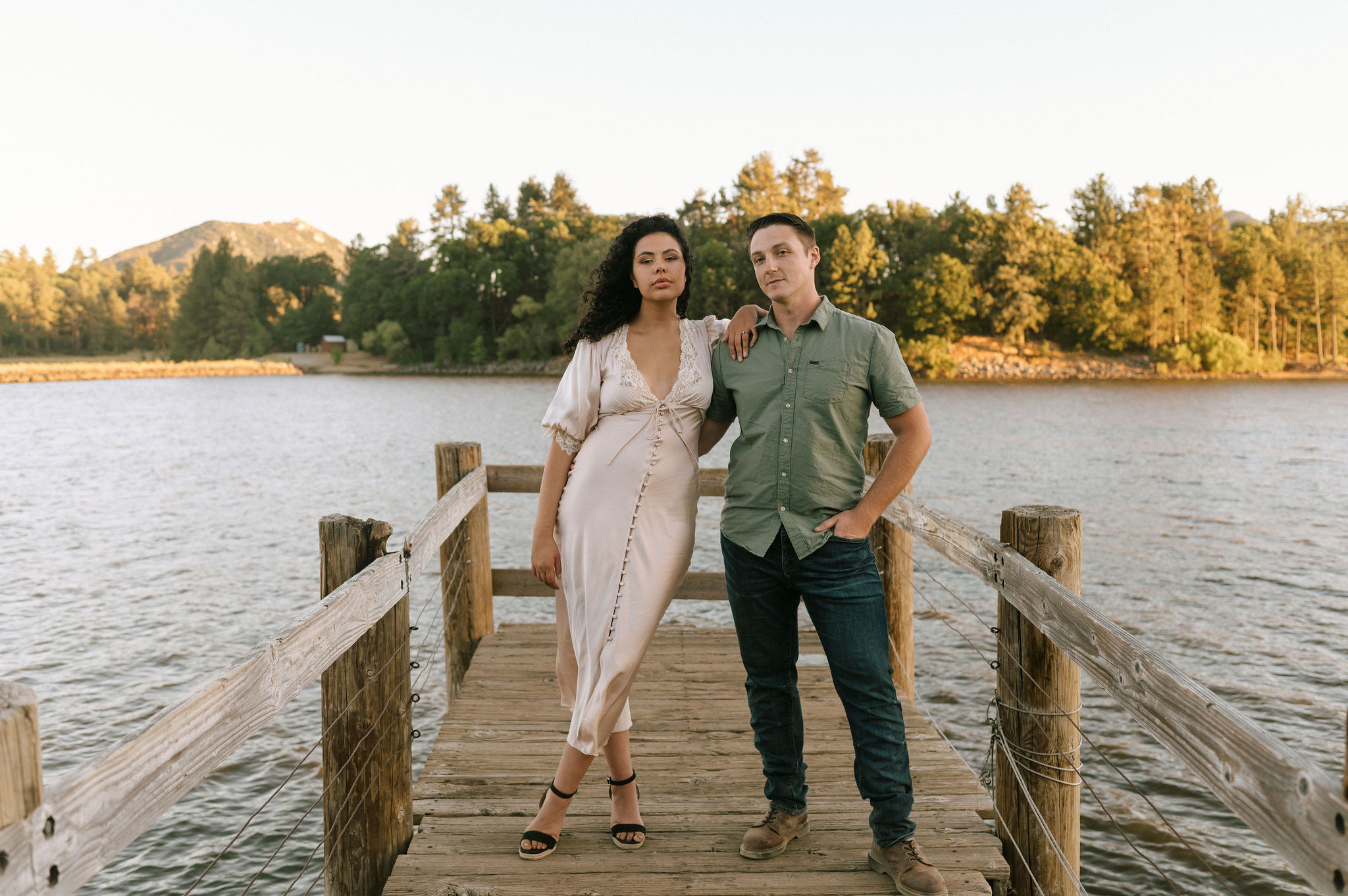A couple standing on a dock during their Lake Cuyamaca engagement session.